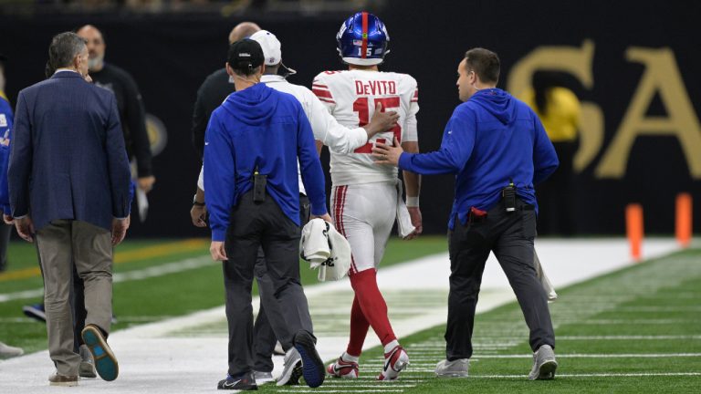 New York Giants quarterback Tommy DeVito (15) is helped off the field after being hit during the first half of an NFL football game against the New Orleans Saints , Dec. 17, 2023, in New Orleans. (Matthew Hinton/AP)