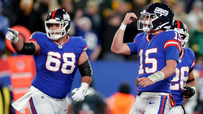 New York Giants quarterback Tommy DeVito (15) and guard Ben Bredeson (68) celebrate after a touchdown against the Green Bay Packers during the third quarter of an NFL football game, Monday, Dec. 11, 2023, in East Rutherford, N.J. (AP Photo/Adam Hunger)