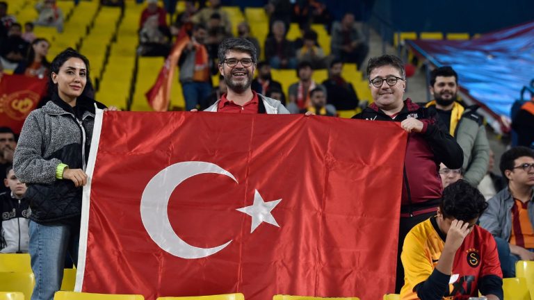 Turkish soccer fans wave their national flag as they wait for the Super Cup match between Galatasaray and Fenerbahce at Al Awal Park of King Saud University in Riyadh, Saudi Arabia, Friday, Dec. 29, 2023. (AP Photo)