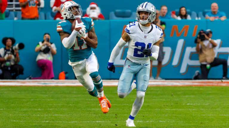 Miami Dolphins wide receiver Jaylen Waddle catches a pass as Dallas Cowboys cornerback Stephon Gilmore (21) defends during the first quarter of an NFL football game on Sunday, Dec. 24, 2023, in Miami Gardens, Fla. (David Santiago/Miami Herald via AP)