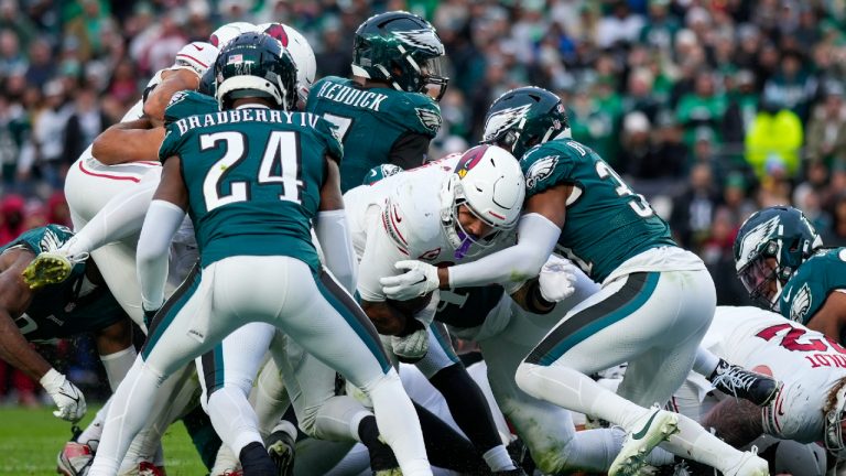 Arizona Cardinals running back James Conner pushes through Philadelphia Eagles defenders while scoring a touchdown during the second half of an NFL football game, Sunday, Dec. 31, 2023, in Philadelphia. The Cardinals won 35-31. (Matt Slocum/AP)