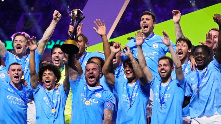 Manchester City's Kyle Walker, center, lifts the trophy at the end of the Soccer Club World Cup final match between Manchester City FC and Fluminense FC at King Abdullah Sports City Stadium in Jeddah, Saudi Arabia, Friday, Dec. 22, 2023. Manchester City won 4-0. (Manu Fernandez/AP Photo)