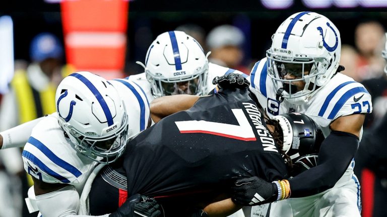 Indianapolis Colts defensive end Kwity Paye (51) and Indianapolis Colts cornerback Kenny Moore II (23) hit Atlanta Falcons running back Bijan Robinson (7) during the first half of an NFL football game, Sunday, Dec. 24, 2023, in Atlanta. (Alex Slitz/AP Photo)