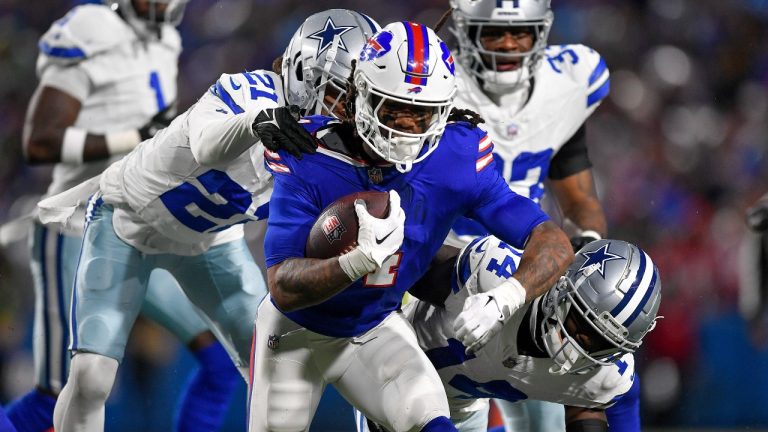 Buffalo Bills running back James Cook (4) tries to avoid the grasp of Dallas Cowboys cornerback Stephon Gilmore (21) during the second quarter of an NFL football game, Sunday, Dec. 17, 2023, in Orchard Park, N.Y. (Adrian Kraus/AP Photo)