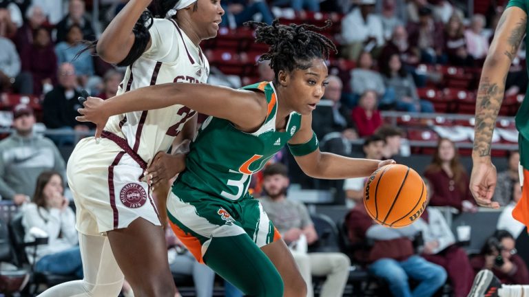 Miami guard Shayeann Day-Wilson (30) works against tight defense from Mississippi State guard Debreasha Powe (21) during an NCAA basketball game on Wednesday, Nov. 29, 2023, Starkville, Miss. (Vasha Hunt/AP Photo)