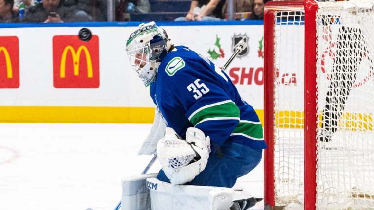 Vancouver Canucks' goaltender Thatcher Demko (35) stops the puck during the third period of an NHL game against the Florida Panthers in Vancouver on Thursday, Dec. 14, 2023. (Ethan Cairns/CP)