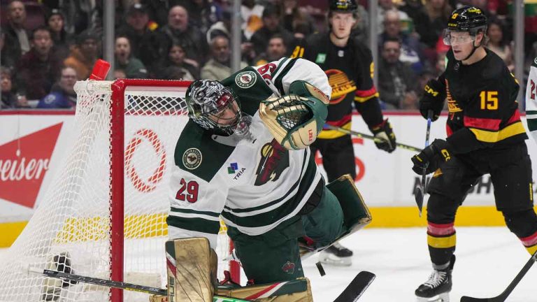 The puck bounces back out of the net from behind Minnesota Wild goalie Marc-Andre Fleury (29) after Vancouver Canucks' Brock Boeser scores during an NHL game. (Darryl Dyck/THE CANADIAN PRESS)