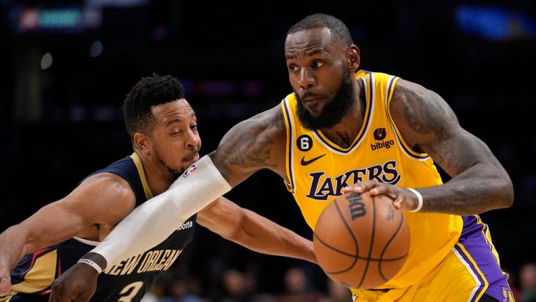 Los Angeles Lakers forward LeBron James, right, drives by New Orleans Pelicans guard CJ McCollum during the second half of an NBA basketball game Wednesday, Nov. 2, 2022, in Los Angeles. (Mark J. Terrill/AP)