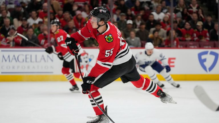 Chicago Blackhawks defenseman Kevin Korchinski clears the puck of his team's zone during the first period of an NHL hockey game against the Toronto Maple Leafs(Erin Hooley/AP)