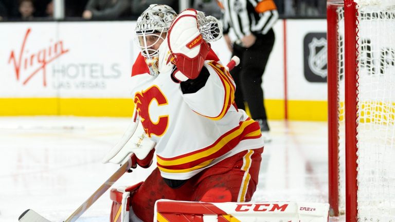 Calgary Flames goaltender Jacob Markstrom makes a glove-save during the second period of an NHL hockey game against the Vegas Golden Knights, Thursday, March 16, 2023, in Las Vegas. (Ellen Schmidt/AP Photo)