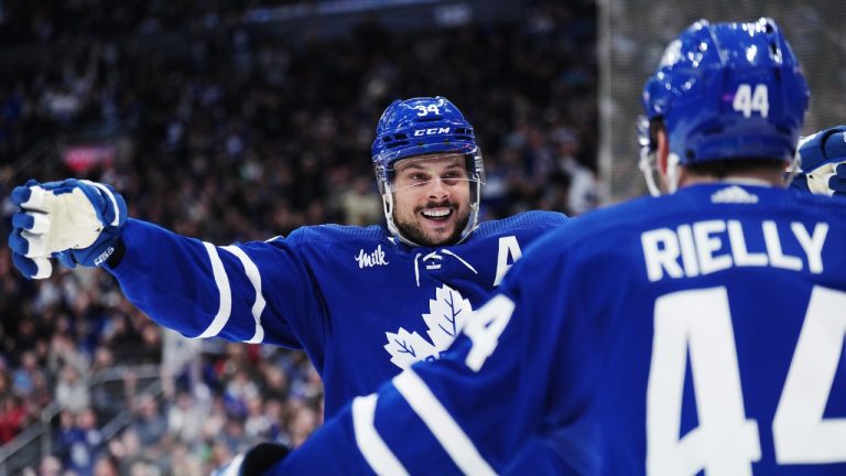 Toronto Maple Leafs forward Auston Matthews (34) celebrates his goal against the New York Rangers with defenceman Morgan Rielly (44) during second period NHL hockey action in Toronto on Tuesday, December 19, 2023. (Nathan Denette/CP)