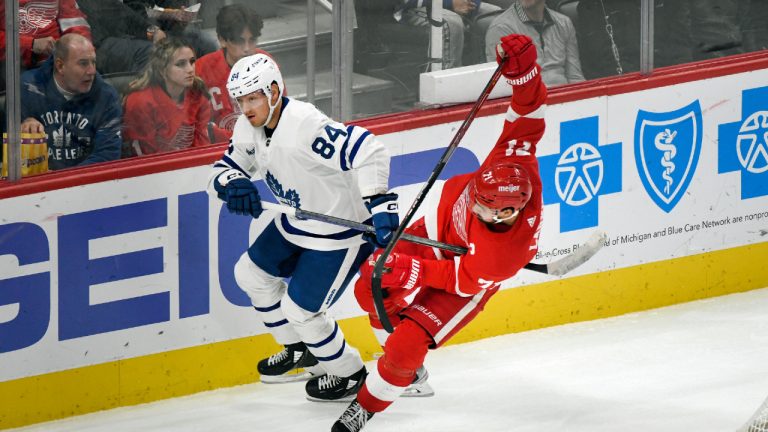 Detroit Red Wings' Dylan Larkin, right, falls after colliding with Toronto Maple Leafs' Mikko Kokkonen during the third period of an NHL preseason hockey game, Friday, Oct. 7, 2022, in Detroit. (Jose Juarez/AP)