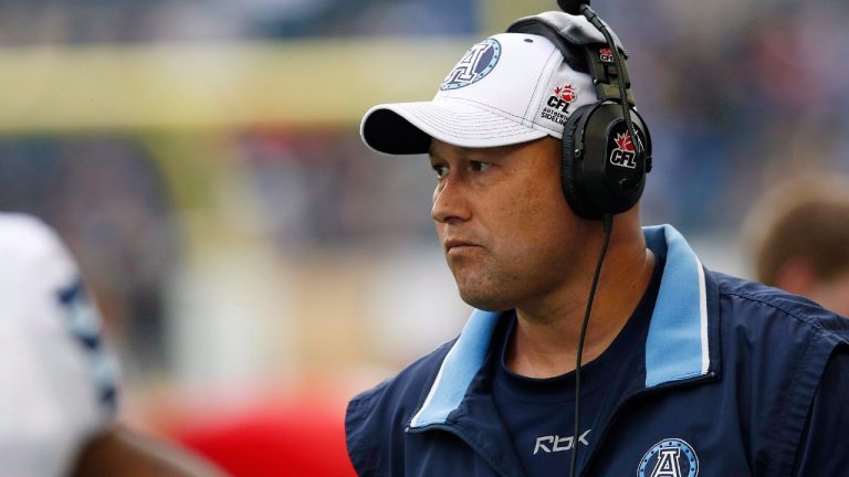 Scott Milanovich, then head coach of the Toronto Argonauts, stands on the sidelines during the first half of CFL action against the Winnipeg Blue Bombers in Winnipeg on June 26, 2014. (John Woods/CP)