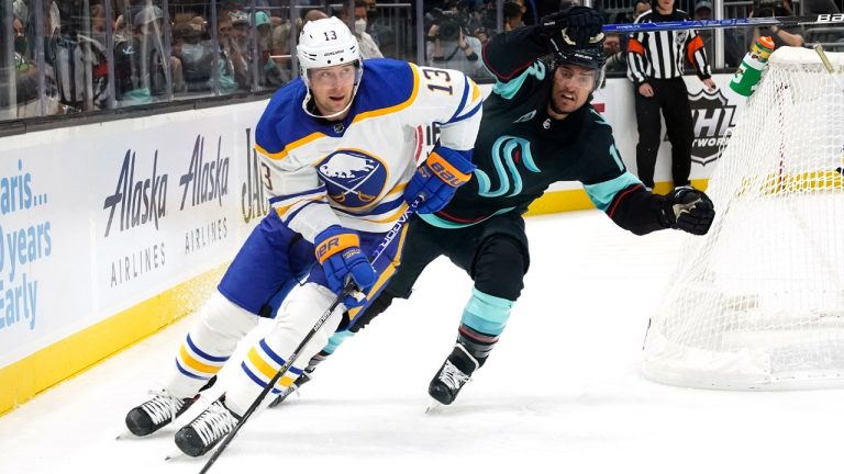 Buffalo Sabres' Mark Pysyk, left, skates past Seattle Kraken's Brandon Tanev during the first period of an NHL hockey game Thursday, Nov. 4, 2021, in Seattle. (Elaine Thompson/AP)