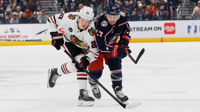 Chicago Blackhawks' Lukas Reichel, left, and Columbus Blue Jackets' Justin Danforth chase the puck during the first period of an NHL hockey game Wednesday, Nov. 22, 2023, in Columbus, Ohio. (Jay LaPrete/AP)