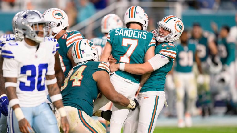 Miami Dolphins punter Jake Bailey (16) hugs Miami Dolphins kicker Jason Sanders (7) as they celebrate Sanders kicking the game winning field goal during an NFL football game against the Dallas Cowboys, Sunday, Dec 24, 2023, in Miami Gardens, Fla. (Doug Murray/AP)