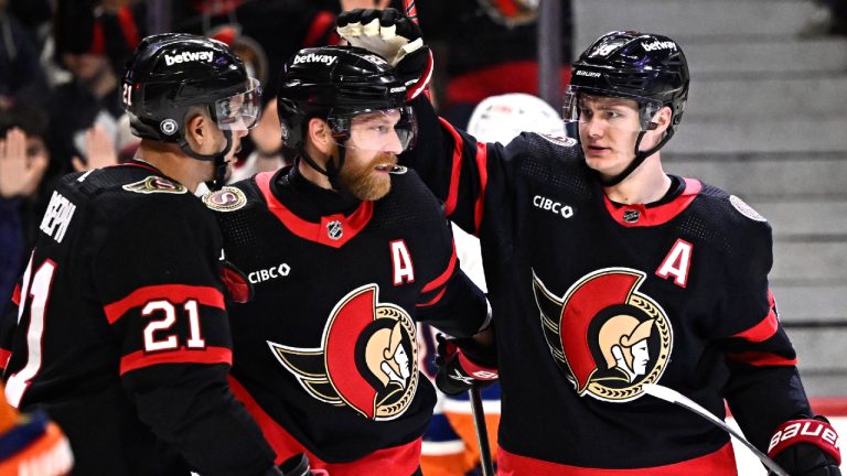 Ottawa Senators' Tim Stutzle (18) celebrates his goal against the New York Islanders with Claude Giroux (28) and Mathieu Joseph (21) during second period NHL hockey action in Ottawa, on Friday, Nov. 24, 2023. (Justin Tang/CP)