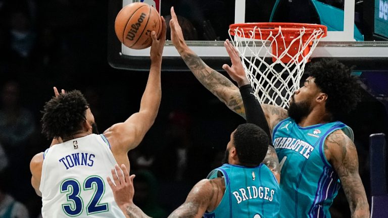 Charlotte Hornets centre Nick Richards, right, blocks a shot by Minnesota Timberwolves center Karl-Anthony Towns and forward Miles Bridges looks on during the first half of an NBA basketball game Saturday, Dec. 2, 2023, in Charlotte, N.C. (Chris Carlson/AP)