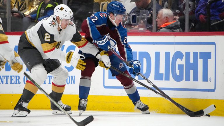 Colorado Avalanche left wing Fredrik Olofsson, right, reaches for the puck next to Vegas Golden Knights defenceman Zach Whitecloud during the second period of an NHL hockey game Wednesday, Jan. 10, 2024, in Denver. (David Zalubowski/AP)