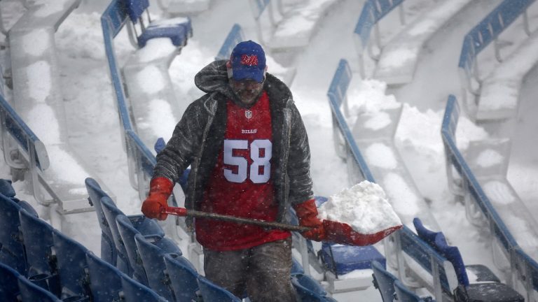 A worker helps remove snow from Highmark Stadium in Orchard Park, N.Y., Sunday Jan. 14, 2024. A potentially dangerous snowstorm that hit the Buffalo region on Saturday led the NFL to push back the Bills wild-card playoff game against the Pittsburgh Steelers from Sunday to Monday. New York Gov. Kathy Hochul and the NFL cited public safety concerns for the postponement, with up to 2 feet of snow projected to fall on the region over a 24- plus hour period. (Jeffrey T. Barnes/AP)