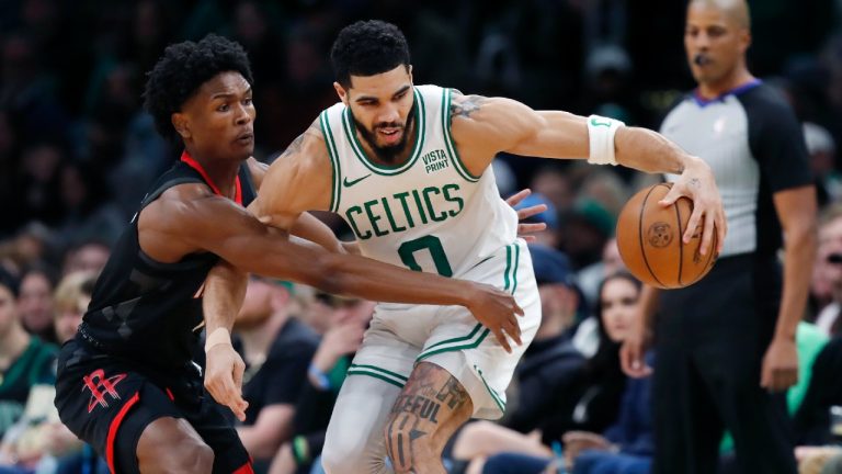 Boston Celtics' Jayson Tatum (0) keeps the ball away from Houston Rockets' Amen Thompson during the first half of an NBA basketball game, Saturday, Jan. 13, 2024, in Boston. (Michael Dwyer/AP)