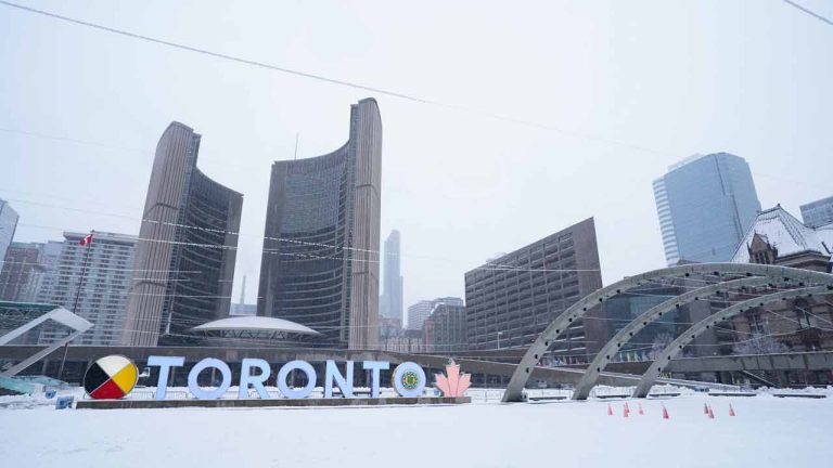 Toronto City Hall is seen during a snow storm in Toronto, Saturday, March 4, 2023. Environment Canada has issued a winter storm warning for much of southern Ontario. (Arlyn McAdorey/CP)