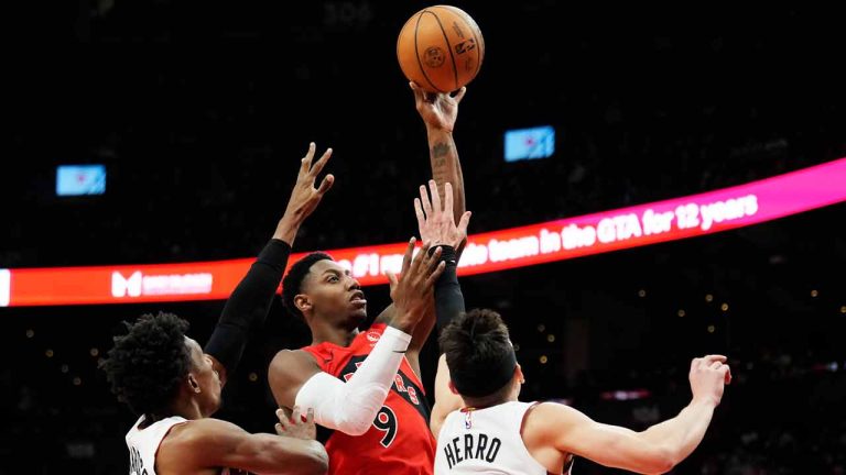 Toronto Raptors guard RJ Barrett (9) shoots over Miami Heat guard Josh Richardson (left) and guard Tyler Herro (14) during first half NBA basketball action in Toronto on Wednesday, Jan. 17, 2024. (Frank Gunn/CP)