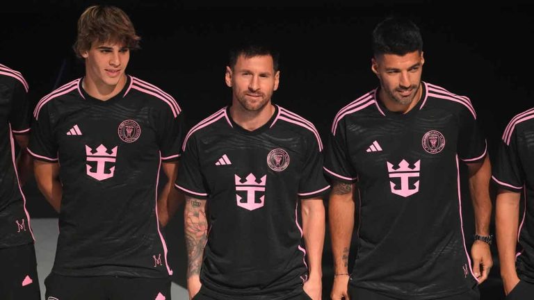 Inter Miami soccer player Lionel Messi, center, stands with his teammates Benjamin Cremaschi, left, and Luis Suarez, right, as they wear new uniforms with the Royal Caribbean International logo during an event on the world's largest cruise ship Icon of the Seas, Tuesday, Jan. 23, 2024, in Miami. The MLS soccer team Inter Miami CF has formed a partnership with the cruise line Royal Caribbean International. (Lynne Sladky/AP)