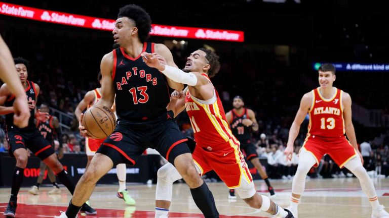 Atlanta Hawks guard Trae Young (11) battles against Toronto Raptors' Jordan Nwora (13) during the first half of an NBA basketball game Sunday, Jan. 28, 2024, in Atlanta. (Miguel Martinez/Atlanta Journal-Constitution via AP)