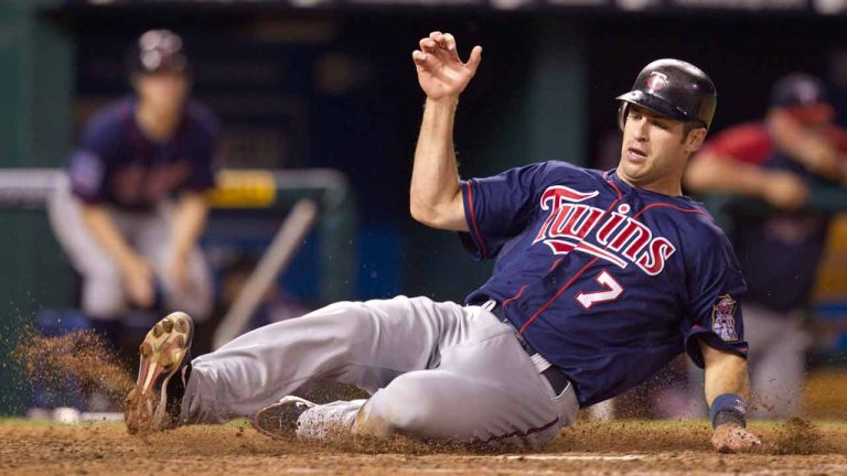 Minnesota Twins' Joe Mauer scores on a Delmon Young single during the eighth inning of a baseball game against the Kansas City Royals on Tuesday, July 27, 2010, in Kansas City, Mo. The Twins won 11-2. (Charlie Riedel/AP)