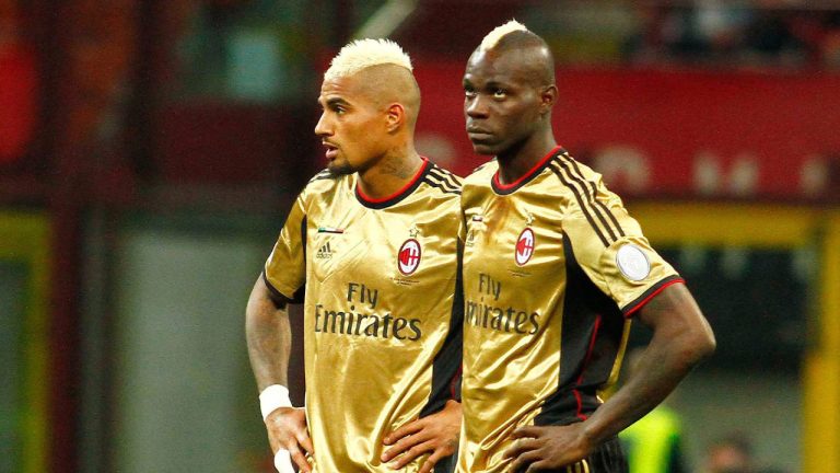 FILE - In this Sunday May 12, 2013, file photo, AC Milan players Kevin Prince Boateng, left, and Mario Balotelli look toward the stands during a stoppage in play in a Serie A soccer match between AC Milan and AS Roma, at Milan's San Siro Stadium. The game was stopped for almost two minutes because of racial abuse by Roma fans towards Balotelli and Boateng. (Davide Spada/AP)