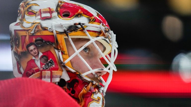 Calgary Flames goaltender Jacob Markstrom has an illustration of Johnny Cash on his mask as he warms up before an NHL hockey game against the Chicago Blackhawks, Sunday, Jan. 7, 2024, in Chicago. (AP)