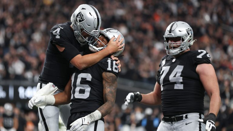 Las Vegas Raiders wide receiver Jakobi Meyers (16) is congratulated by quarterback Aidan O'Connell (4) and offensive tackle Kolton Miller (74) after scoring a touchdown against the Denver Broncos during the first half of an NFL football game, Sunday, Jan. 7, 2024 in Las Vegas. (Ellen Schmidt/AP)