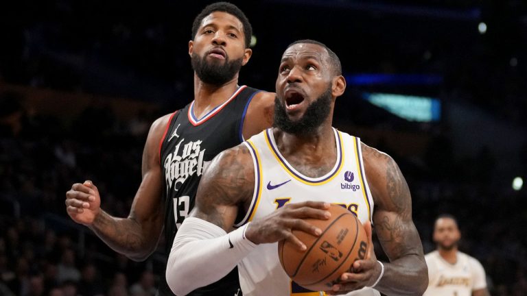 Los Angeles Lakers forward LeBron James, front right, drives to the basket against Los Angeles Clippers forward Paul George (13) during the first half of an NBA basketball game in Los Angeles, Sunday, Jan. 7, 2024. (Eric Thayer/AP)