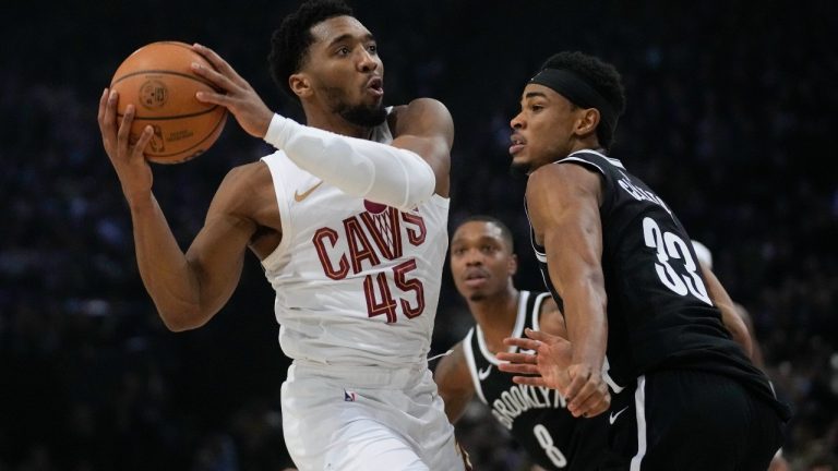 Cleveland Cavaliers' Donovan Mitchell, left, drives to the basket during the NBA basketball game between Brooklyn Nets and Cleveland Cavaliers, at the Accor Arena in Paris, Thursday, Jan. 11, 2024. (Christophe Ena/AP)