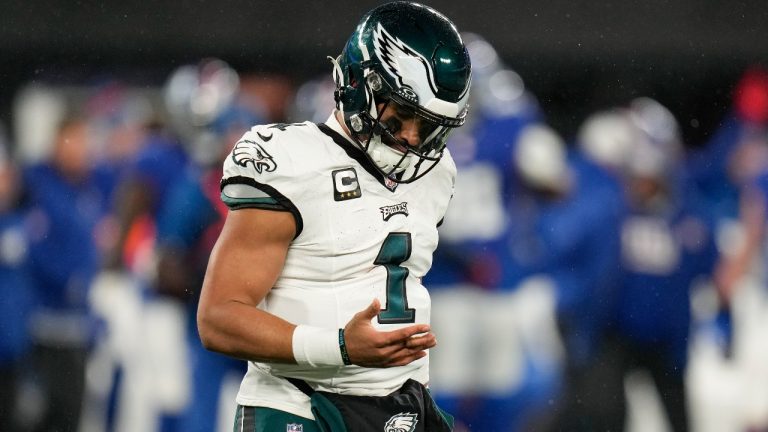 Philadelphia Eagles quarterback Jalen Hurts (1) walks off the field with a finger injury during the second quarter of an NFL football game against the New York Giants, Sunday, Jan. 7, 2024, in East Rutherford, N.J. (Seth Wenig/AP)