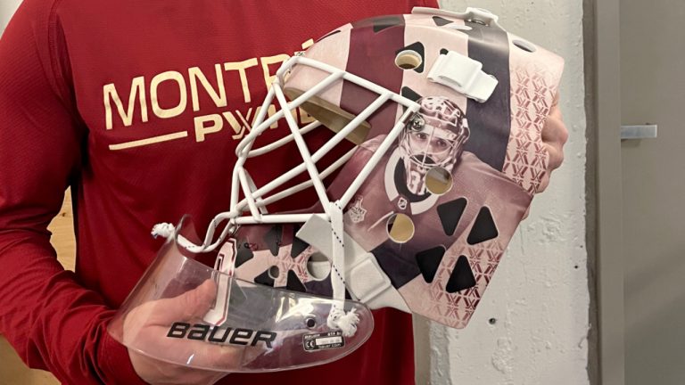 PWHL Montreal goalie Elaine Chuli holds her new mask, which pays tribute to some Montreal goalie greats including Ken Dryden and Carey Price, in Montreal, Friday, Jan. 26, 2024. (Daniel Rainbird/CP)