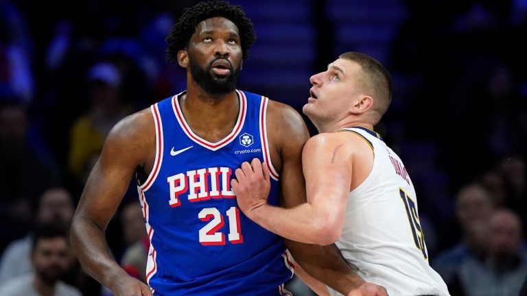 Philadelphia 76ers' Joel Embiid, left, and Denver Nuggets' Nikola Jokic struggle for position during the first half of an NBA basketball game, Tuesday, Jan. 16, 2024, in Philadelphia. (Matt Slocum/AP)