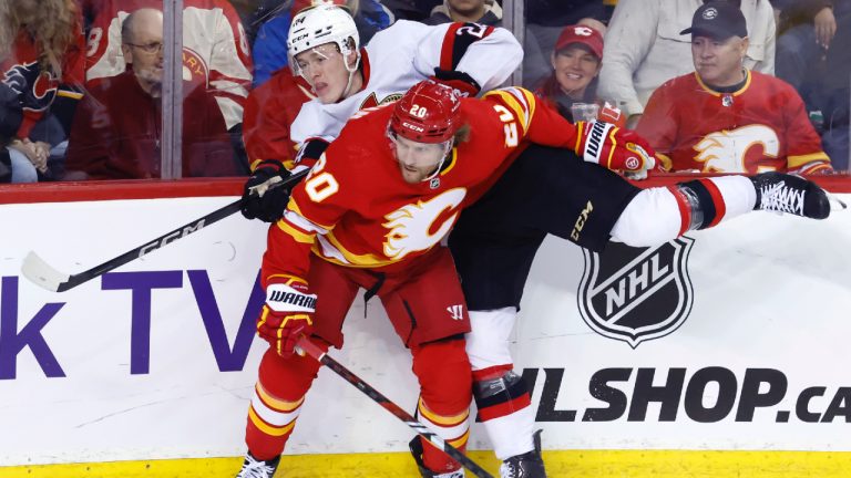 Calgary Flames' Blake Coleman (20) hits Ottawa Senators' Jacob Bernard-Docker during first period NHL hockey action in Calgary, Tuesday, Jan. 9, 2024. (Larry MacDougal/CP)