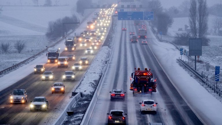 A salt truck drives on a snow covered highway in Frankfurt, Germany, after snow fall. (Michael Probst/AP)