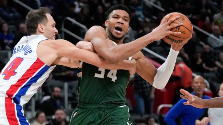 Milwaukee Bucks forward Giannis Antetokounmpo, right, is fouled by Detroit Pistons forward Bojan Bogdanovic, left, in the first half of an NBA basketball game. (Paul Sancya/AP)