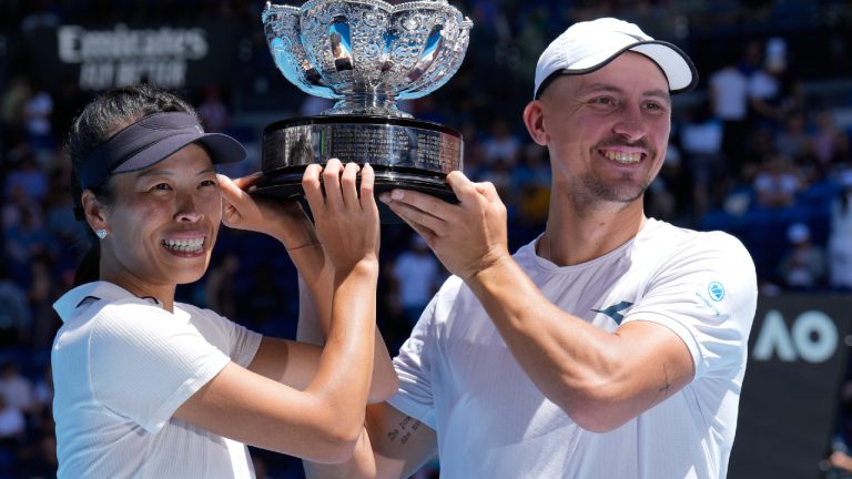 Hsieh Su-Wei of Taiwan and Jan Zielinski of Poland hold their trophy aloft after defeating Desirae Krawczyk of the U.S. and Neal Skupski of Britain in the mixed doubles final at the Australian Open tennis championships at Melbourne Park, Melbourne, Australia, Friday, Jan. 26, 2024. (Andy Wong/AP)