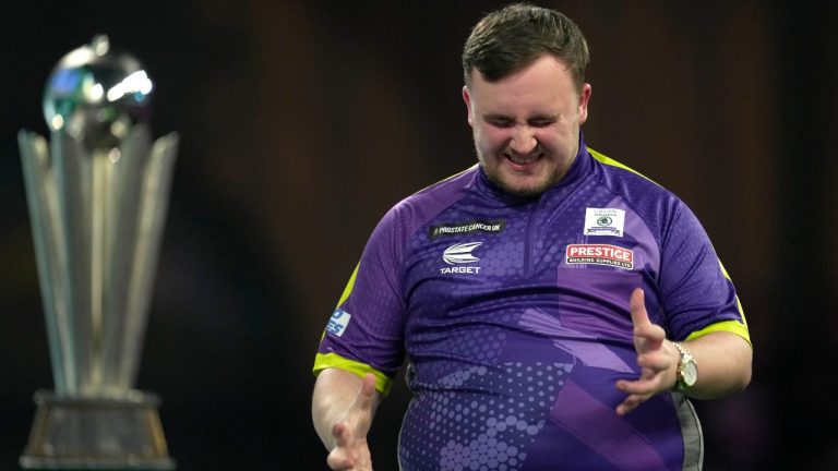 Luke Littler grimaces during the final match against Luke Humphries of England at the World Darts Championship, in London, Wednesday, Jan. 3, 2024. (AP Photo/Kin Cheung)