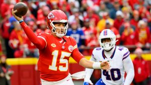 Kansas City Chiefs quarterback Patrick Mahomes (15) throws while being chased by Buffalo Bills linebacker Von Miller (40). (Reed Hoffmann/AP)