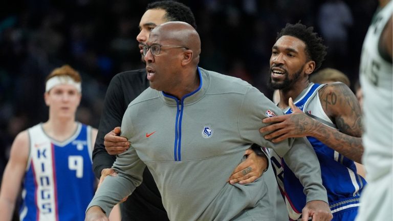 Sacramento Kings head coach Mike Brown is restrained by Malik Monk as he argues a call during the second half of an NBA basketball game against the Milwaukee Bucks Sunday, Jan. 14, 2024, in Milwaukee. (Morry Gash/AP Photo)