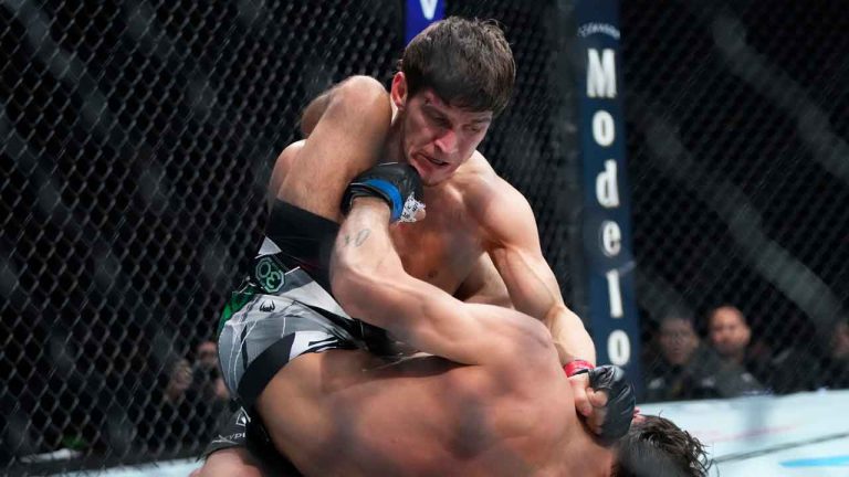 Russia's Movsar Evloev, left, punches Brazil's Diego Lopes during the first round of a featherweight bout at the UFC 288 mixed martial arts event. (Frank Franklin II/AP)