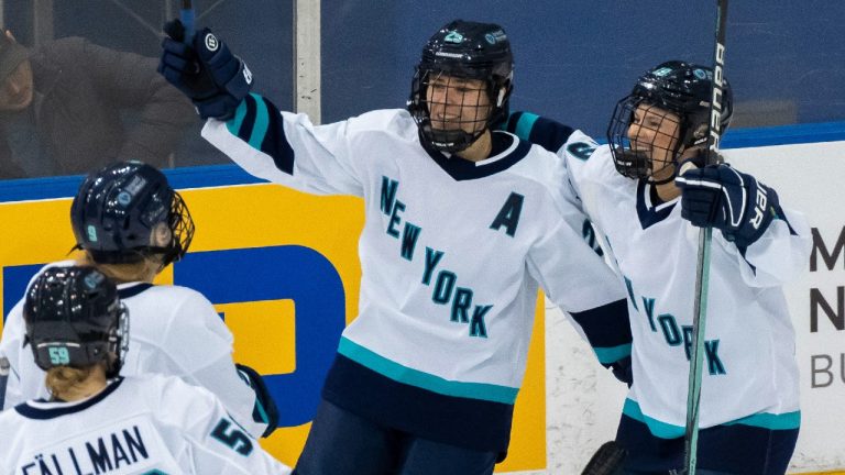 New York forward Alex Carpenter (25) is congratulated by teammates Paetyn Levis (19), Jade Downie-Landry (9) and Johanna Fallman after scoring against Toronto during third period action in Toronto on Monday January 1, 2024. (Frank Gunn/CP)