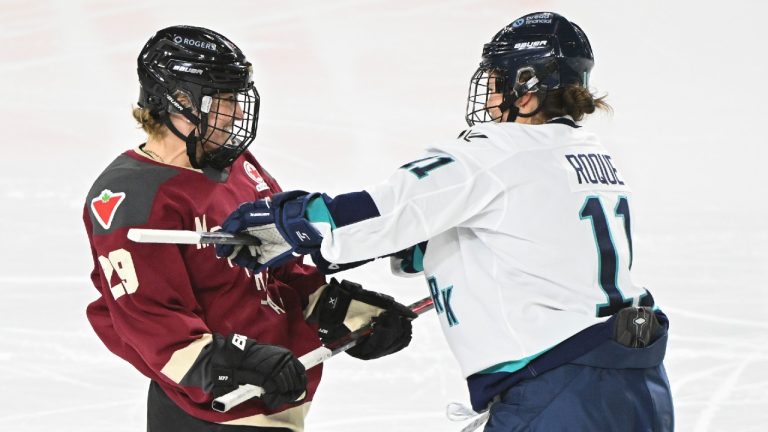 New York's Abby Roque (11) crosschecks Montreal's Marie-Philip Poulin during second period PWHL hockey action in Laval, Que., Tuesday, January 16, 2024. (Graham Hughes/CP)