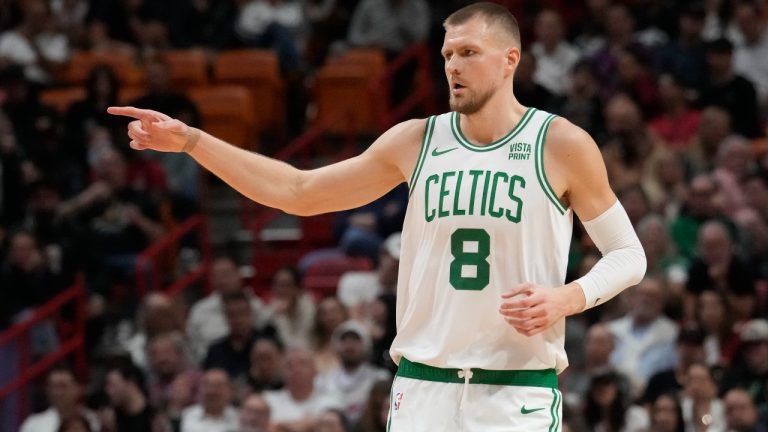 Boston Celtics center Kristaps Porzingis (8) gestures after scoring a three-point basket during the first half of an NBA basketball game against the Miami Heat, Thursday, Jan. 25, 2024, in Miami. (Marta Lavandier/AP)