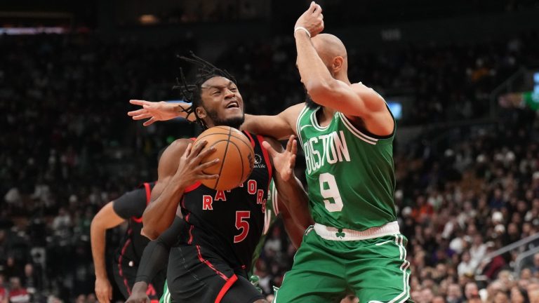 Toronto Raptors guard Immanuel Quickley (5) drives towards the basket as Boston Celtics guard Derrick White (9) defends during first half NBA basketball action in Toronto Monday Jan. 15, 2024. (Nathan Denette/AP)